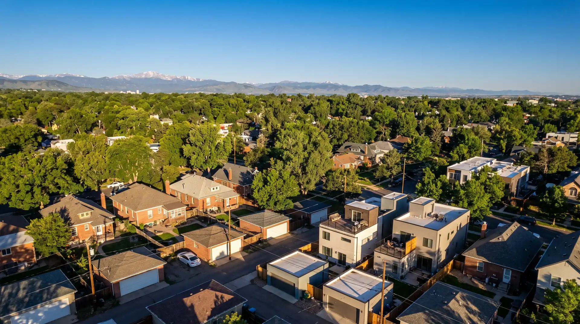 Aerial view over a leafy Denver residential neighborhood in late afternoon