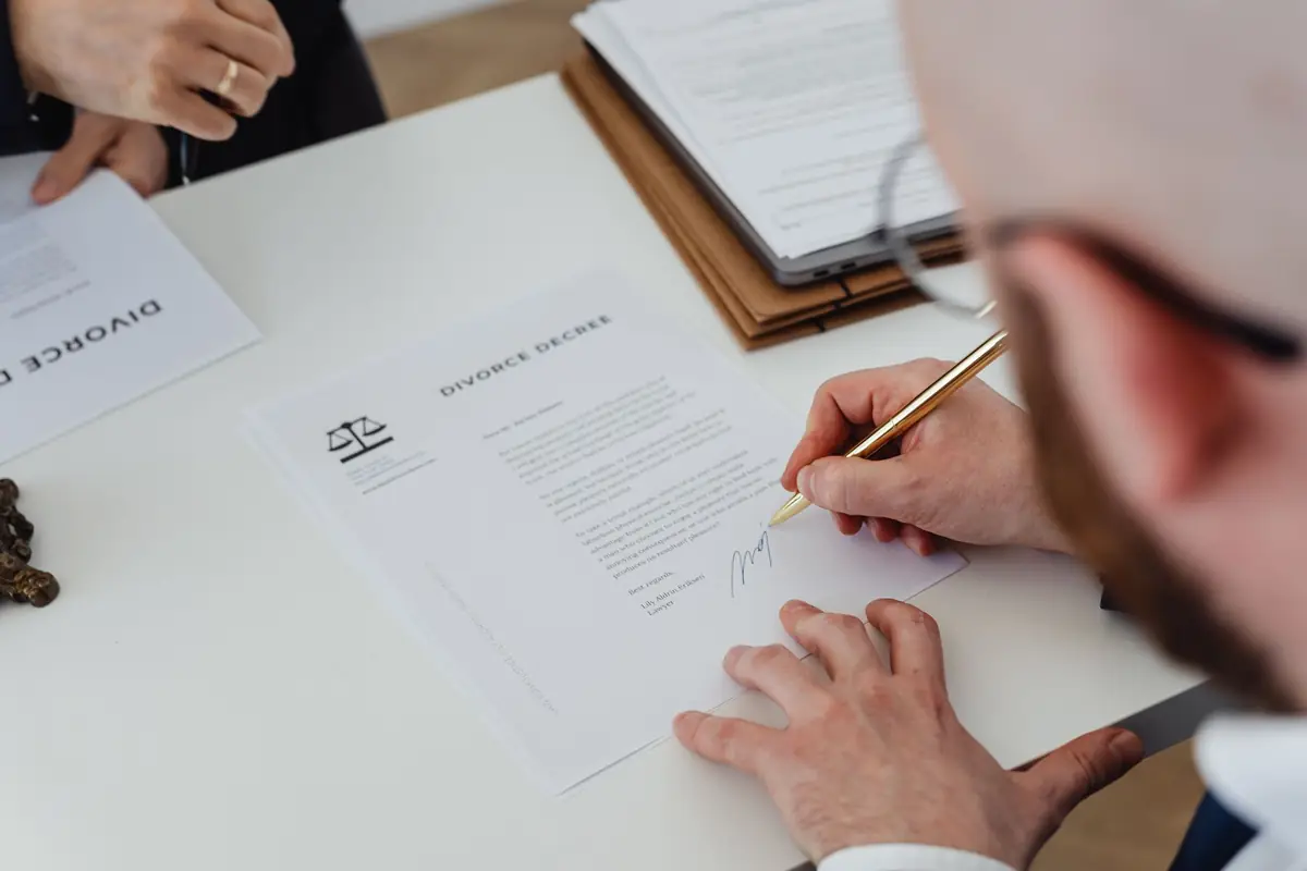 Contract documents and a pen on a desk